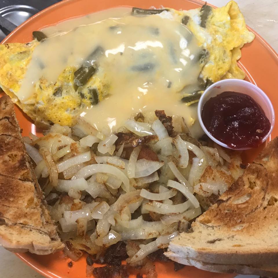 fried potatoes and onions with omelet and toast